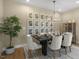 Elegant dining room with decorative lighting, seating for six, and a curated gallery wall at 158 Vaughan Farms Drive Dr, Angier, NC 27501