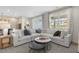 Spacious living room with a large sectional sofa, modern coffee tables, and abundant natural light at 158 Vaughan Farms Drive Dr, Angier, NC 27501