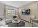 Bright living room featuring a comfortable white sofa, stylish decor, and ample natural light at 158 Vaughan Farms Drive Dr, Angier, NC 27501