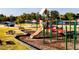 Community playground featuring a slide, climbing structures, and a nearby pond, perfect for Gathering fun at 158 Vaughan Farms Drive Dr, Angier, NC 27501