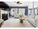 Bright and airy living room with a fireplace, comfortable seating, and large windows at 16106 Morehead, Chapel Hill, NC 27517