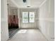 Bathroom under construction with shower, two windows and bare walls at 1701 Burnette Garden Path, Raleigh, NC 27612