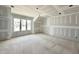 Unfinished bedroom featuring a vaulted ceiling, multiple windows, and walls ready for paint at 1701 Burnette Garden Path, Raleigh, NC 27612