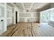 Spacious living room with large windows and wood flooring partially installed at 1701 Burnette Garden Path, Raleigh, NC 27612