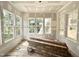 Room with flooring and stack of wood flooring with three large windows at 1701 Burnette Garden Path, Raleigh, NC 27612