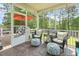 Relaxing screened-in back porch with stylish outdoor furniture and a view of the lush greenery at 187 Farrah-Shea Way, Angier, NC 27501