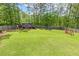 Spacious backyard featuring a wooden storage shed, lush green lawn, and swing at 187 Farrah-Shea Way, Angier, NC 27501