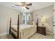 Charming bedroom features a four-poster bed, neutral tones, and stylish coastal decor at 187 Farrah-Shea Way, Angier, NC 27501