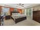 Spacious bedroom featuring a ceiling fan, windows, and coastal decor at 187 Farrah-Shea Way, Angier, NC 27501