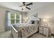 Cozy bedroom with ceiling fan, patterned bedding, and natural light from the window at 187 Farrah-Shea Way, Angier, NC 27501