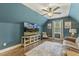 Inviting bonus room with a large television, comfortable seating, and hardwood floors at 187 Farrah-Shea Way, Angier, NC 27501