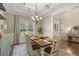 Traditional dining room featuring tray ceiling, chandelier, wainscotting, and hardwood floors at 187 Farrah-Shea Way, Angier, NC 27501