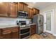 Well-equipped kitchen with stainless steel appliances, granite countertops, and wood cabinets at 187 Farrah-Shea Way, Angier, NC 27501