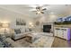 Cozy living room with fireplace, ceiling fan, and comfortable seating, perfect for Gathering gatherings and relaxation at 187 Farrah-Shea Way, Angier, NC 27501