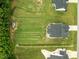 Aerial view of a large green lawn, backyard, shed, and gray roofed home at 206 Heart Pine Dr, Wendell, NC 27591