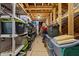 An unfinished attic shows the rafters and has items stored in plastic containers and boxes at 206 Heart Pine Dr, Wendell, NC 27591