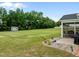 An expansive backyard with a shed, lush lawn, patio and screened-in porch at 206 Heart Pine Dr, Wendell, NC 27591