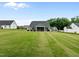 Beautiful backyard view of a home's expansive, green lawn and screened-in porch at 206 Heart Pine Dr, Wendell, NC 27591