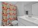 A full bathroom with single sink, toilet, and tub with colorful shower curtain at 206 Heart Pine Dr, Wendell, NC 27591
