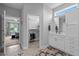 Bright bathroom with a walk-in closet and a vanity featuring white cabinets and drawers at 206 Heart Pine Dr, Wendell, NC 27591