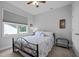 Bright bedroom with a large window, comfortable bed, and modern interior design at 206 Heart Pine Dr, Wendell, NC 27591