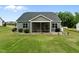 A partial, elevated view of a home's exterior backyard with a porch and green lawn at 206 Heart Pine Dr, Wendell, NC 27591