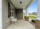 Spacious covered porch with white bench and views of the quiet neighborhood at 206 Heart Pine Dr, Wendell, NC 27591