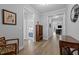 Light-filled hallway showcasing beautiful flooring and access to multiple rooms at 206 Heart Pine Dr, Wendell, NC 27591