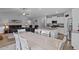 Bright, open-concept kitchen with granite island, stainless steel appliances, and adjacent dining and living areas at 206 Heart Pine Dr, Wendell, NC 27591