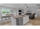 Open concept kitchen with granite island, stainless steel dishwasher and adjacent dining and living areas at 206 Heart Pine Dr, Wendell, NC 27591