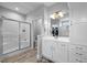 Bright bathroom with a glass shower, double vanity, and access to a walk-in closet at 206 Heart Pine Dr, Wendell, NC 27591