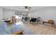 Bright home office with light wood floors, ceiling fan, area rug, desk, and large window with horizontal blinds at 206 Heart Pine Dr, Wendell, NC 27591