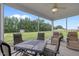 Screened-in patio with outdoor seating and a view of the landscaped yard at 206 Heart Pine Dr, Wendell, NC 27591