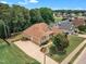 This aerial view showcases the home, front yard, and side entry garage, set amongst mature trees at 212 Fieldtrial Cir, Garner, NC 27529