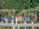 Aerial view showcases homes with manicured lawns, mature trees, and neighborhood streets at 212 Fieldtrial Cir, Garner, NC 27529