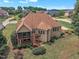 Aerial view of home's exterior, screened-in porch, deck, landscaped yard, and surrounding neighborhood at 212 Fieldtrial Cir, Garner, NC 27529