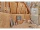 View of unfinished attic storage space with wood walls, ductwork, and mechanical equipment at 212 Fieldtrial Cir, Garner, NC 27529