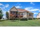 View of home's back exterior with a screened-in porch, deck, stairs, and lush landscaping at 212 Fieldtrial Cir, Garner, NC 27529