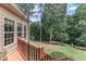 Lovely backyard featuring a deck, steps leading to a spacious lawn, and mature trees offering shade and privacy at 212 Fieldtrial Cir, Garner, NC 27529