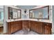 Bathroom with dual vanities, granite countertops, and ample storage with mirrors above at 212 Fieldtrial Cir, Garner, NC 27529