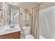 Cozy bathroom showcasing a single sink vanity, commode, and tub/shower with neutral colored shower curtain at 212 Fieldtrial Cir, Garner, NC 27529