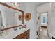 Bathroom vanity with wooden accents and decor, leading to a view of an adjacent bedroom at 212 Fieldtrial Cir, Garner, NC 27529
