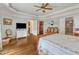 Spacious bedroom with hardwood floors, detailed ceiling trim, and doorways to closet and bathroom at 212 Fieldtrial Cir, Garner, NC 27529