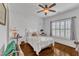 Bright bedroom featuring a ceiling fan, shuttered windows, hardwood floors, and tasteful decor at 212 Fieldtrial Cir, Garner, NC 27529