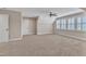 Carpeted bonus room with a ceiling fan and a window with shutters, providing natural light at 212 Fieldtrial Cir, Garner, NC 27529