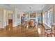 Elegant dining room featuring a fireplace, hardwood floors, and large windows at 212 Fieldtrial Cir, Garner, NC 27529