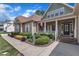 Inviting covered front porch with stone and siding, surrounded by vibrant landscaping at 212 Fieldtrial Cir, Garner, NC 27529