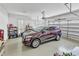 Spacious two-car garage with ample storage space, featuring a dark car parked in the center at 212 Fieldtrial Cir, Garner, NC 27529