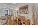 Hallway with hardwood floors leading to a room with an art display at 212 Fieldtrial Cir, Garner, NC 27529