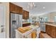 Kitchen with stainless steel appliances, center island, and open layout connecting to other living spaces at 212 Fieldtrial Cir, Garner, NC 27529